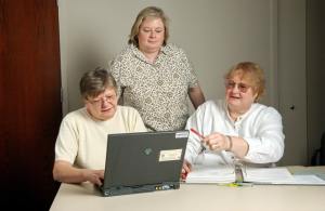 Stock image of three women at a laptop.